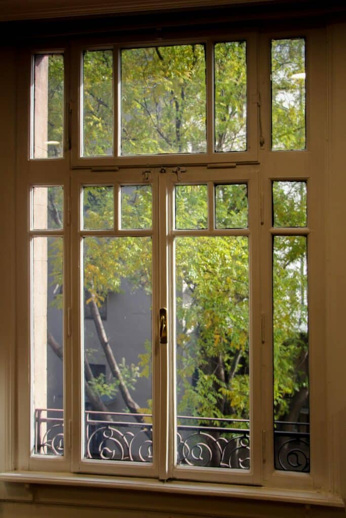 Elegant vintage wooden window just like from a home in Alberta with a relaxing tree view .